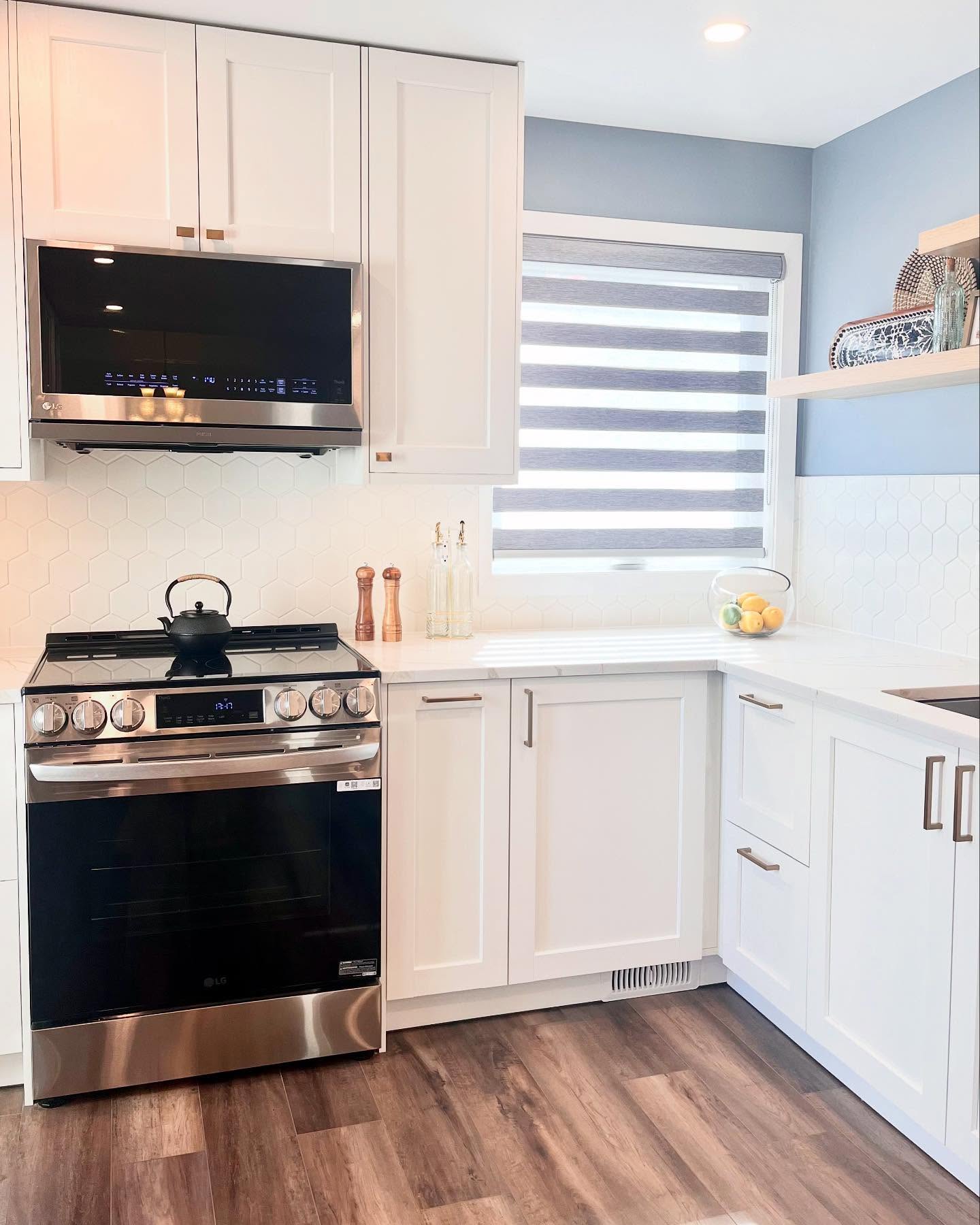 Finished Project Daisy range wall with an LG range, hexagon tile, wood shelves, and dark wood-look flooring