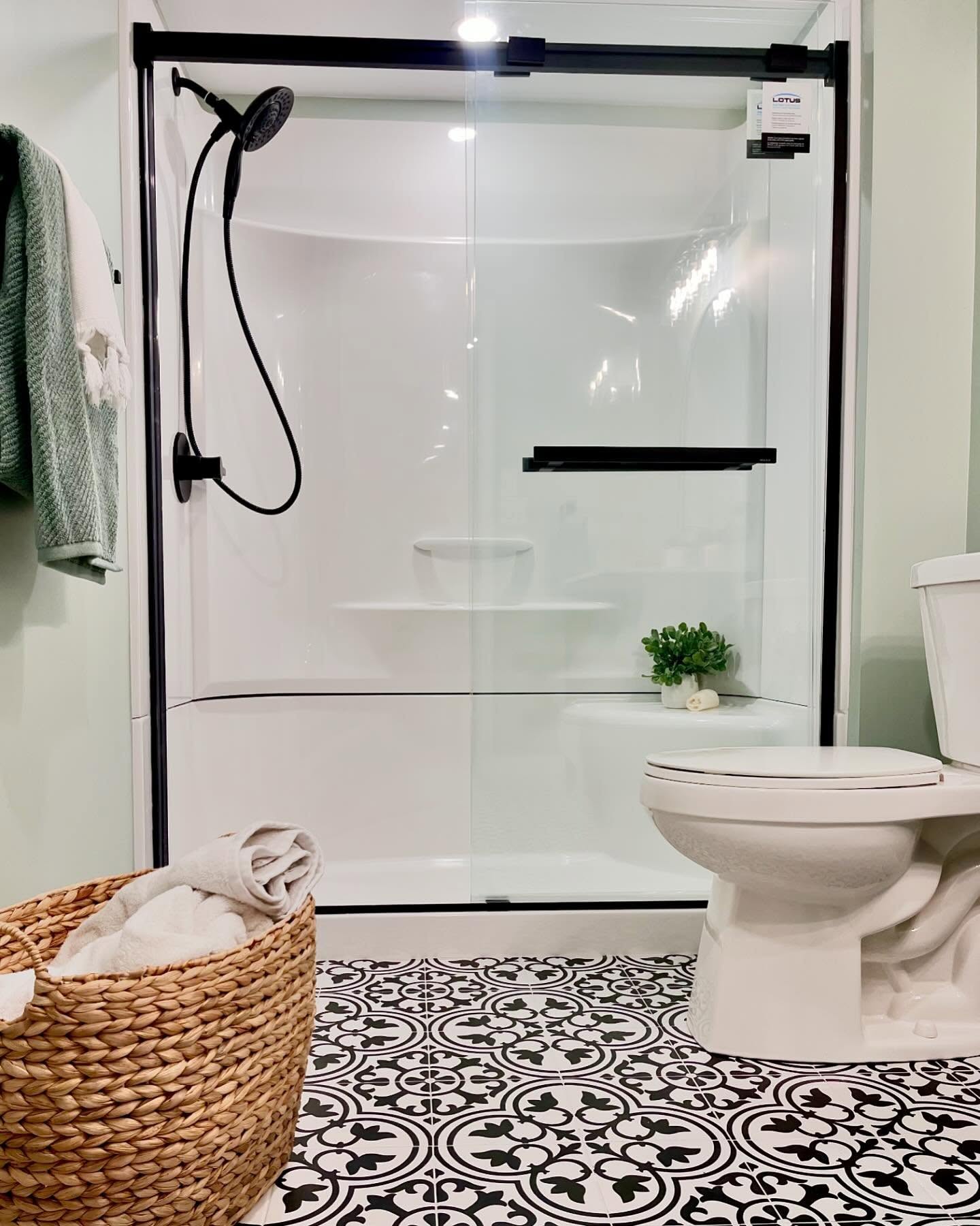 Project Peony basement bathroom with patterned floor tile and a glass shower enclosure