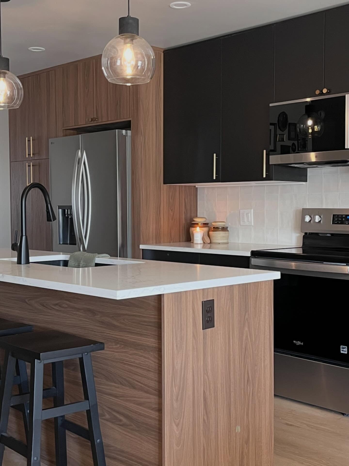 Overview of the island, globe pendants, fridge wall, and range