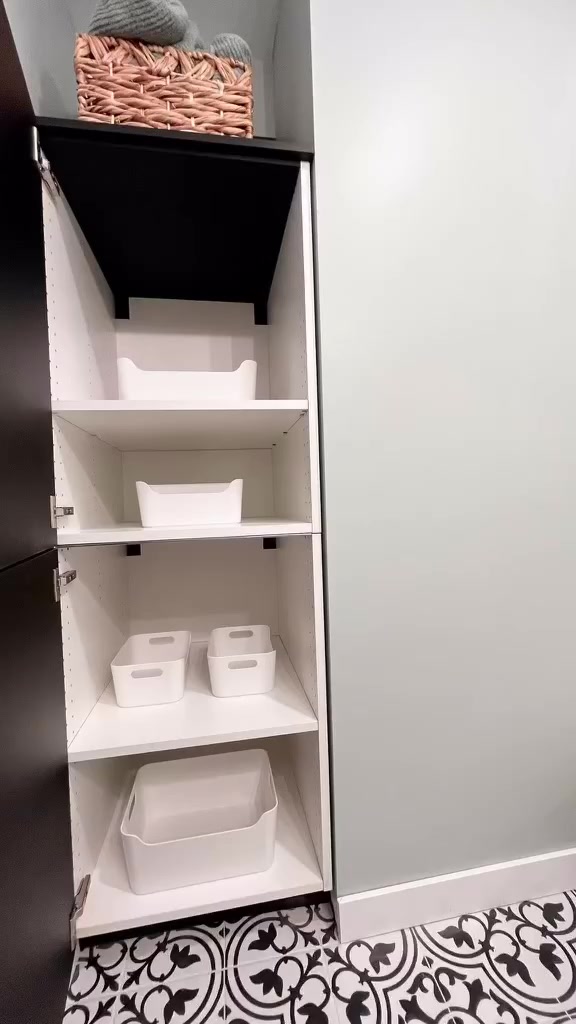 Project Peony built-in storage cabinet with white bins on patterned bathroom floor tile