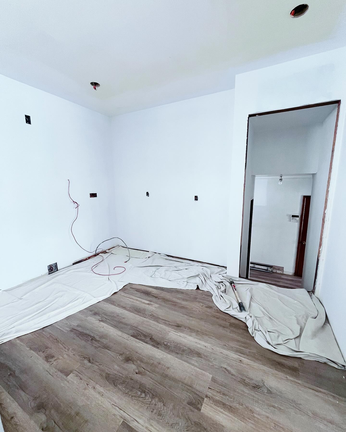 Project Rose kitchen taking shape with new plank floors, white walls, and fresh paint